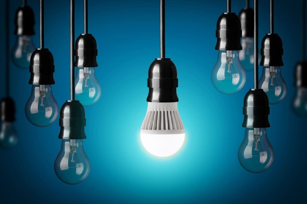 LED lightbulb glowing with other lightbulbs